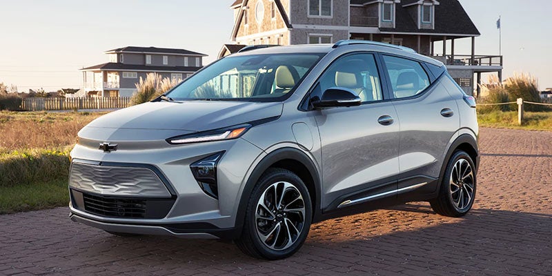 Silver Chevy Bolt EUV parked in front of a house