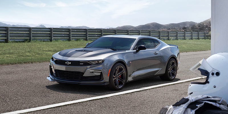 Grey Chevrolet Camaro standing one side of road near white line