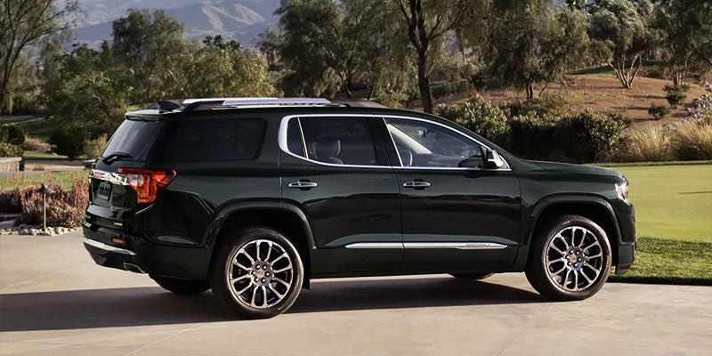 Black Acadia parked near lawns