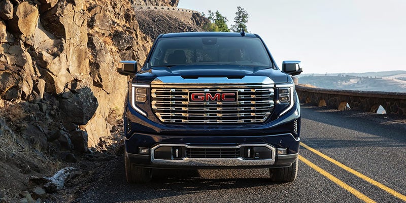 Parked GMC Sierra on a mountain road with scenic views