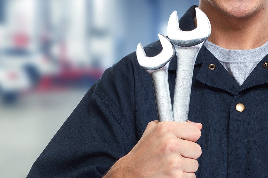 A person holding tools in hand